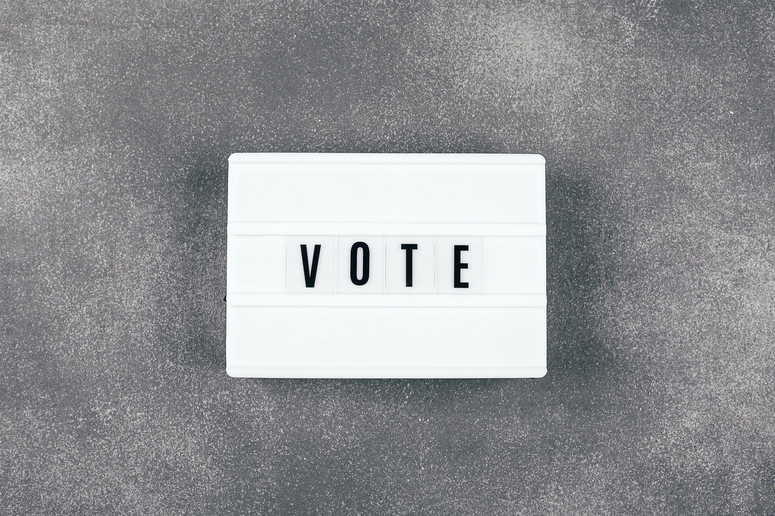 The word VOTE written on lightbox on background. Election concept The word VOTE written on lightbox on background. Election concept